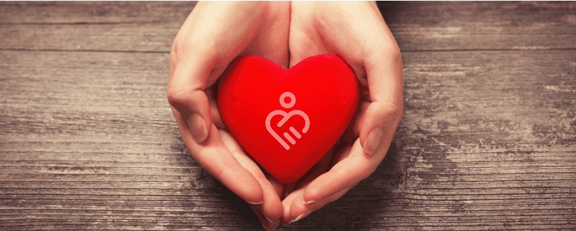 Heart in hand with logo